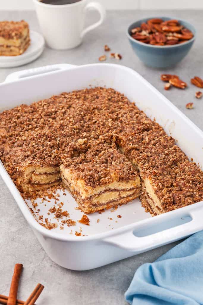 baked coffee cake in a white 9x13 ceramic dish. Sliced into squares and missing three squares