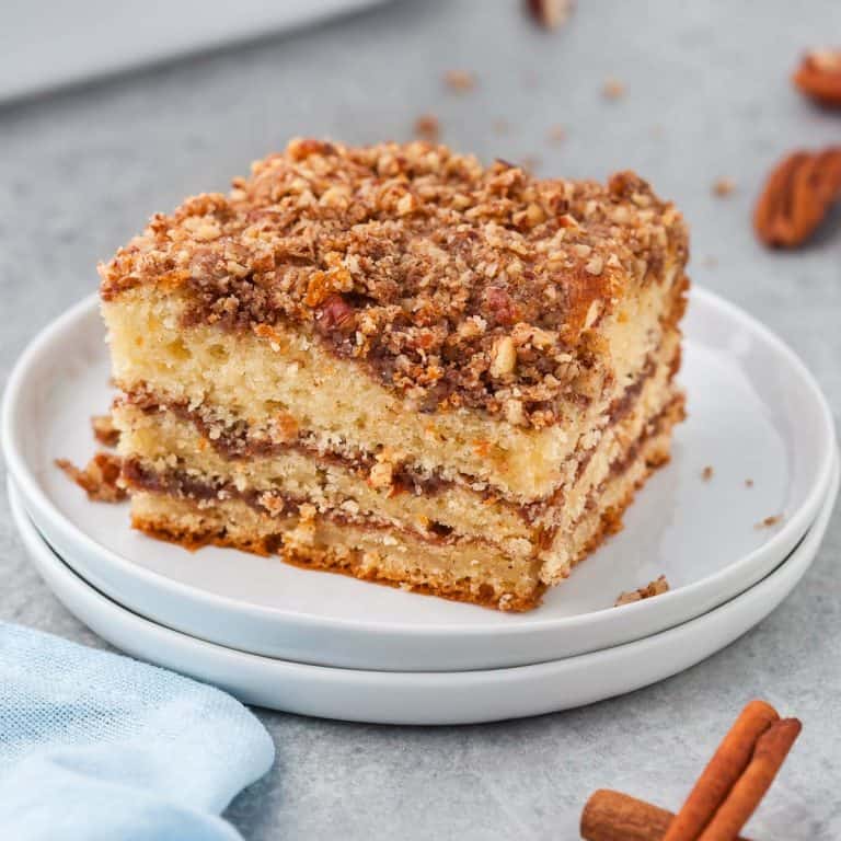 side angle of square slice of cinnamon coffee cake showing three distinct layers