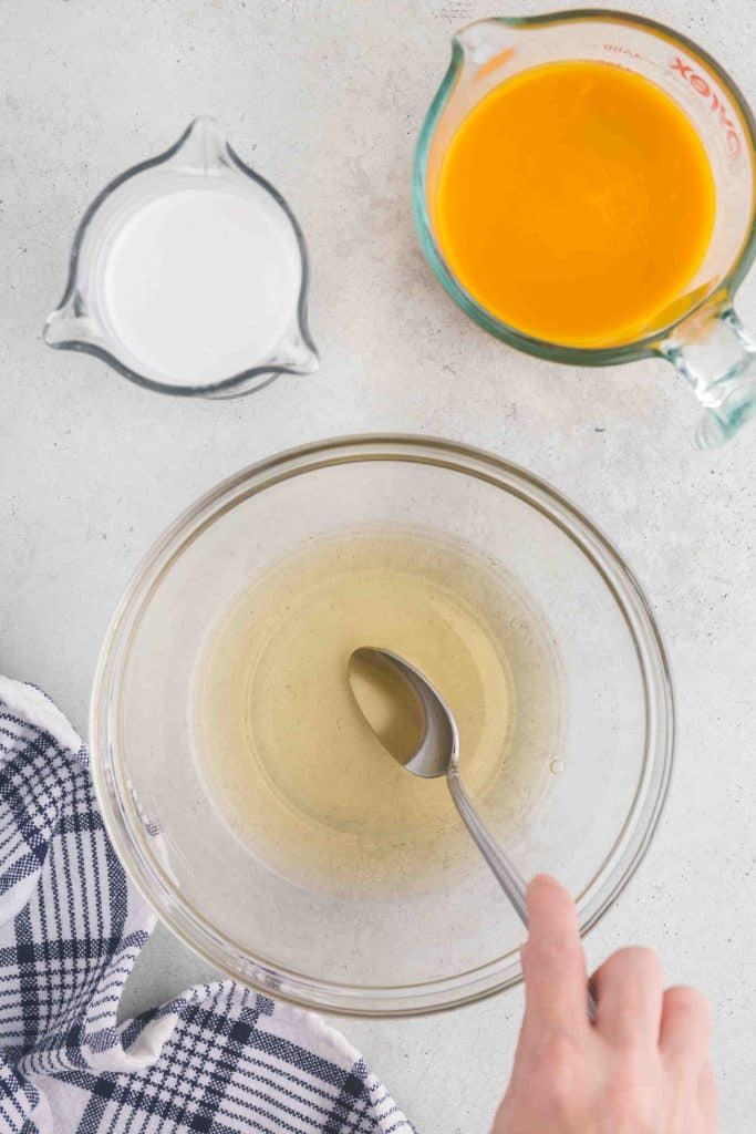 overhead shot showing the sugar and gelatin dissolved in the boiling water. The upper right corner has the mango pulp which will be added next along with the coconut milk in the upper left corner