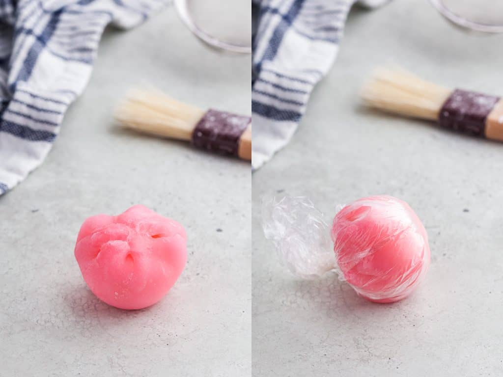 Two side by side pictures. The left picture is of a pink ice cream mochi ball that has just been pinched together and is sitting upside down seam facing upwards. The picture on the right is the same mochi ball that has now been wrapped in plastic wrap and is sitting seam side down.