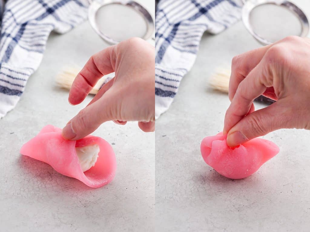 Two side by side pictures. The left picture shows the pink mochi dough being folded over the vanilla ice cream ball in the middle. The picture on the right shows the dough being pinched together to seal off the vanilla ice cream.