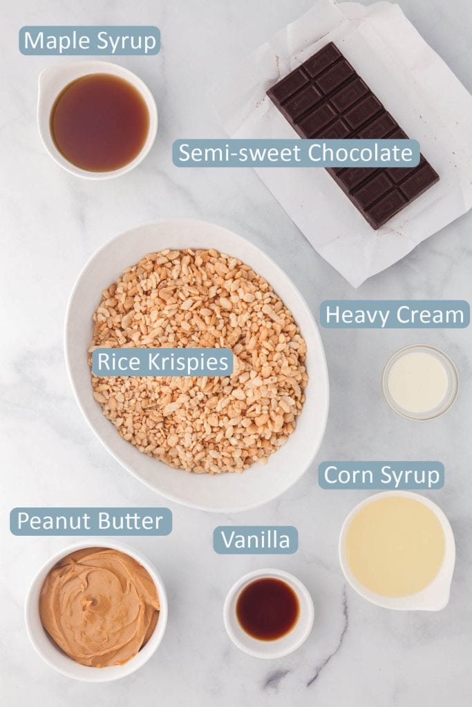 Overhead shot of the ingredients used in making Chocolate Peanut butter rice krispie treats. Ingredients are: maple syrup, corn syrup, semi-sweet chocolate, rice krispies, peanut butter, heavy cream, and vanilla.