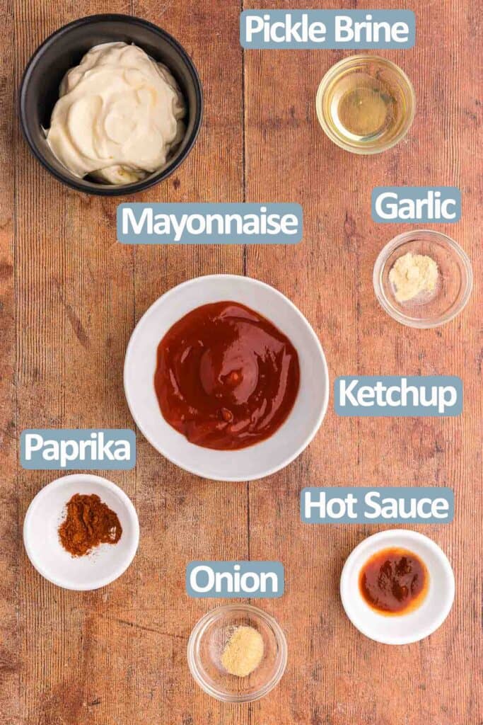 Overhead shot of the ingredients needed to make French fry sauce. Ingredients are: mayonnaise, ketchup, pickle brine, garlic powder, onion powder, hot sauce, and paprika.