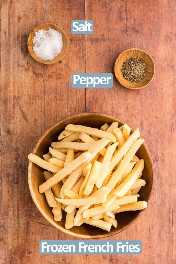 Overhead shot of the ingredients needed to make Frozen French Fries in Air Fryer.  Ingredients are: frozen French fries, salt, and pepper.