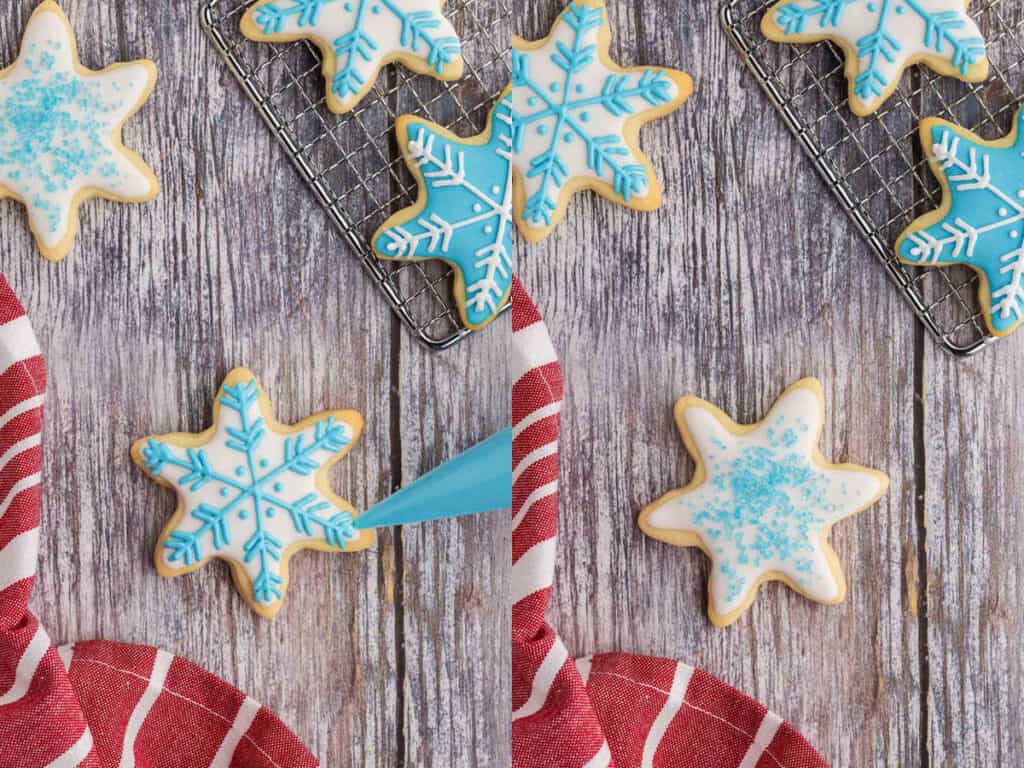 Two side by side overhead shots of snowflake sugar cookies.  On the left a snowflake shaped cookie had been flooded with white royal icing and allowed to dry.  Now a thicker blue royal icing has been used to pipe on an intricate snowflake design.  On the right, a snowflake cookie with flooded and dried white icing has been sprinkled with blue sugar for decoration.