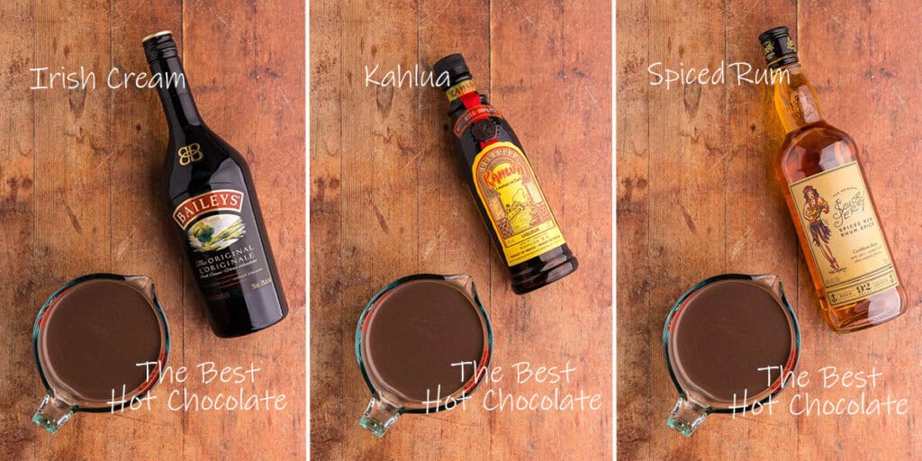 Ingredients used to make spiked Hot chocolate. Overhead shot showing a premade batch of The Best Hot Chocolate, a bottle of Baileys, a bottle of Kahlua, and a bottle of spiced rum.
