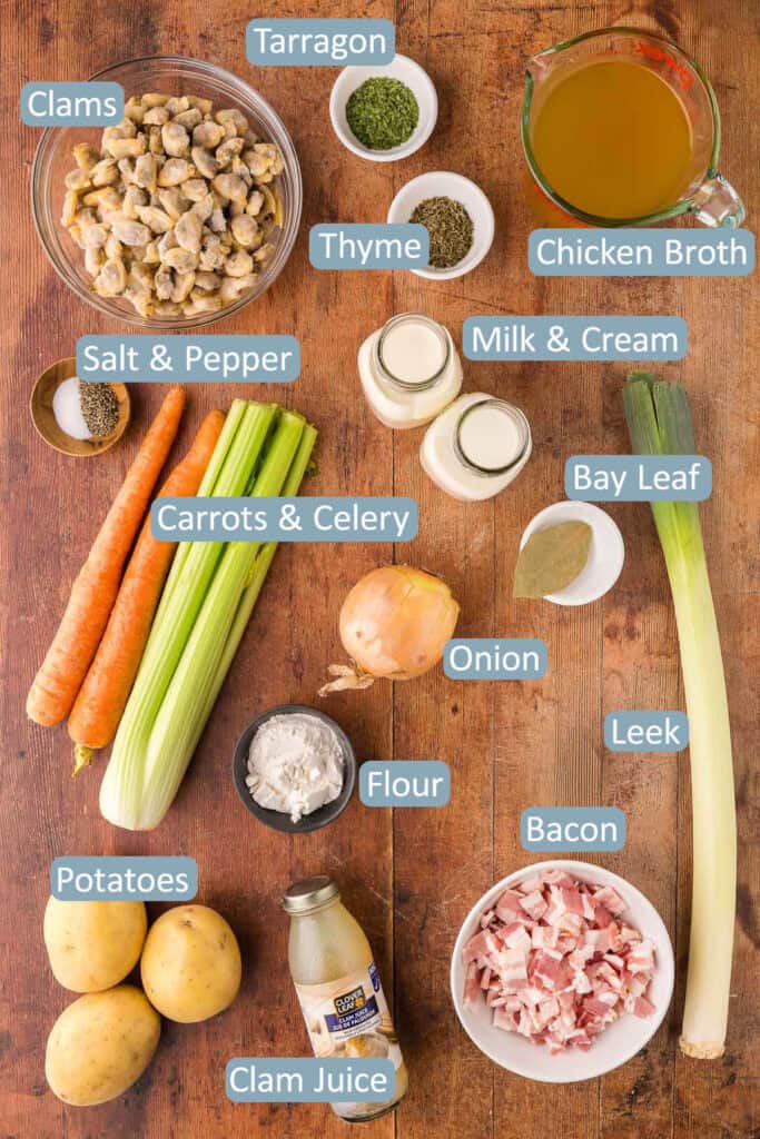 Overhead shot of the ingredients needed to make clam chowder.  Ingredients layed out are: clams, dried tarragon, dried thyme, chicken broth, milk and cream, salt and pepper, carrots, celery, onion, bay leaf, leek, flour, potatoes, clam juice, and bacon.