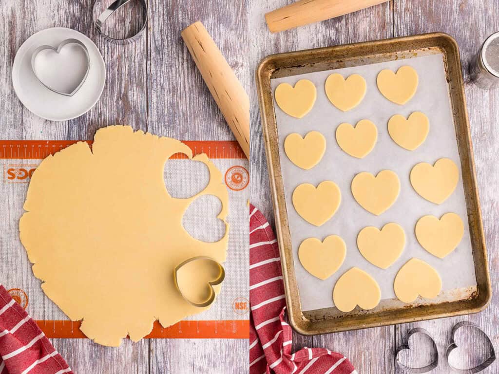 Two pictures side by side.  Left picture is sugar cookie dough that has been rolled out to 1/4" thickness and a heart-shaped cookie cutter is on the surface.  Two heart shapes have already been removed from the dough.  The picture on the right is a sheet pan lined with parchment and heart-shaped sugar cookie dough on it ready to bake.