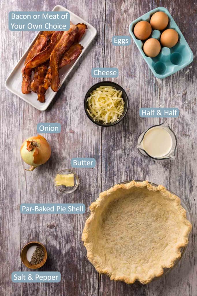 Overhead picture of the ingredients needed to make quiche. For quiche Lorraine it includes: bacon, eggs, cheese, half & half, onion, butter, salt & pepper, and a par-baked pie shell.