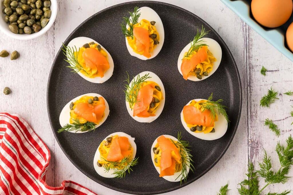 overhead shot of a black plate filled with smoked salmon devilled eggs.