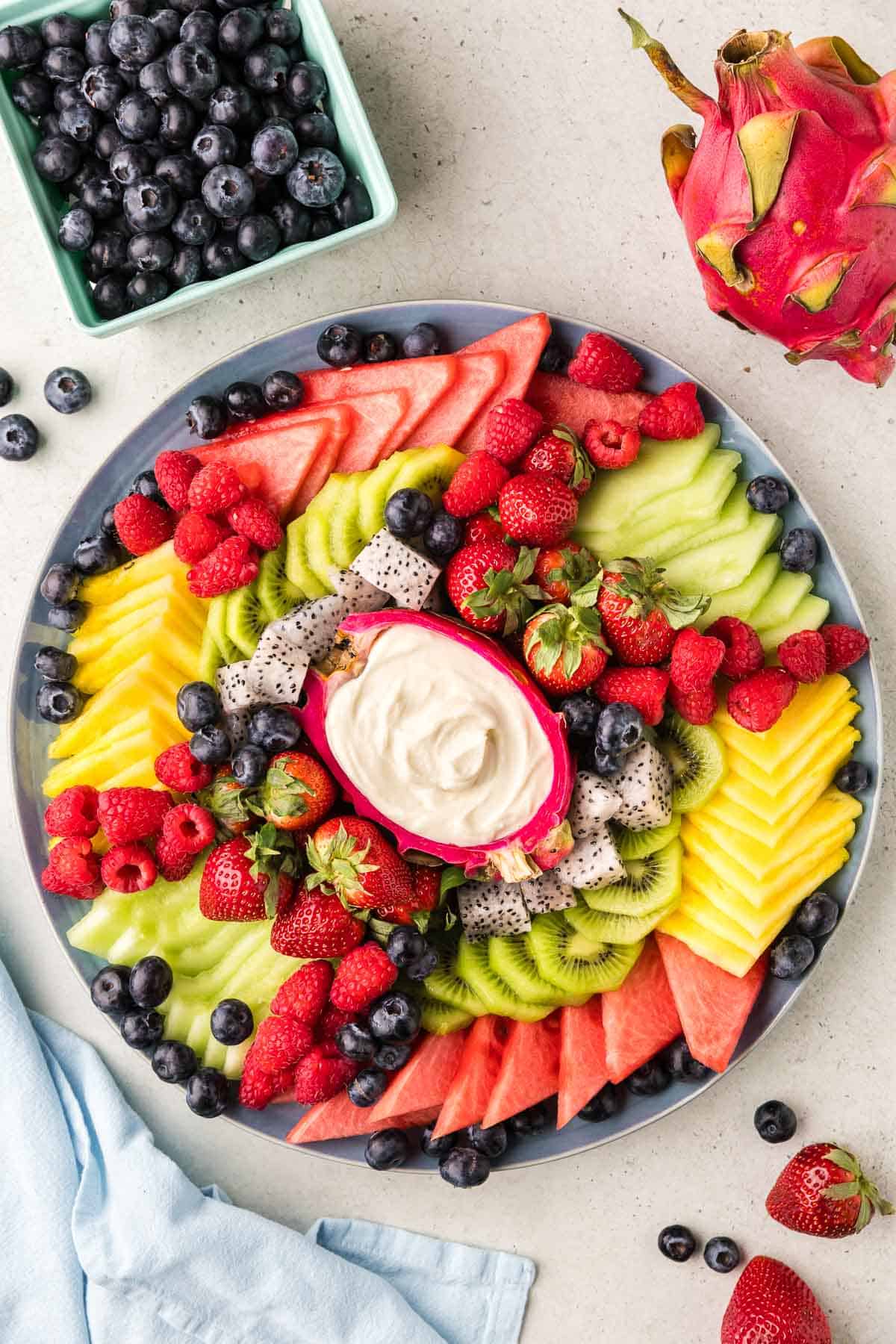 Overhead shot of the final fruit tray with all the fruit and a dip in the middle.