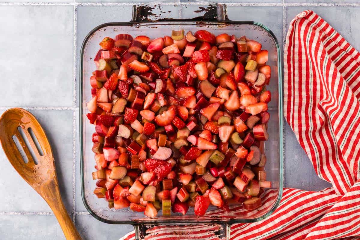 Overhead shot of the strawberry rhubarb crisp filling ingredients in the 9x9 pan.