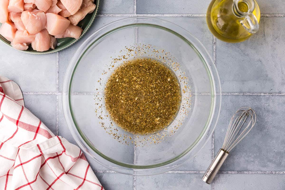Overhead shot of the marinade after all the ingredients have been mixed together. It is a yellowy sauce with lots of garlic and oregano.